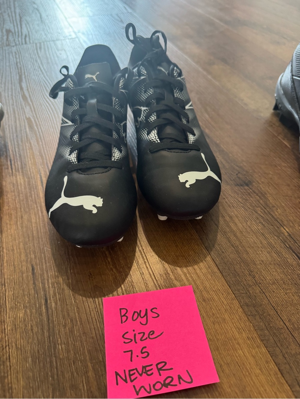 Puma men’s Black and White Cleats